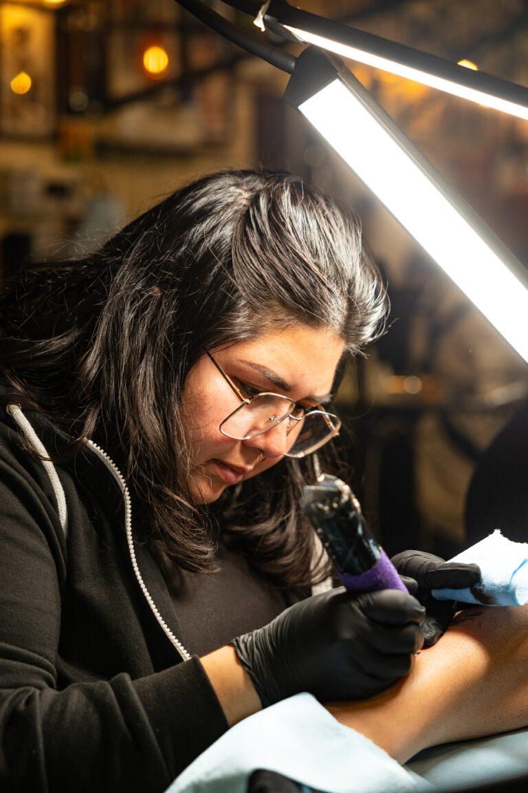 Chapter One artist at work under lamplight